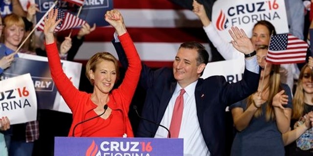 Republican presidential candidate Sen. Ted Cruz, R-Texas, joined by former Hewlett-Packard CEO Carly Fiorina, waves during a rally in Indianapolis, Wednesday, April 27, 2016, when Cruz announced he has chosen Fiorina to serve as his running mate. (AP Photo/Michael Conroy)