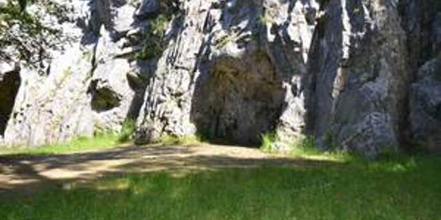 The entrance to the Troisième caverne, Belgium. An international team of researchers has identified butchered remains of Neanderthals from the cave, indicating cannibalism.