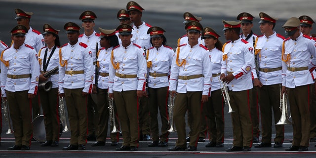 HAVANA, CUBA - SEPTEMBER 19: Cuban military personnel await the arrival of Pope Francis at Jose Marti International Airport on September 19, 2015 in Havana, Cuba. Pope Francis is at the beginning of a three day visit to Cuba where he will meet President Raul Castro and hold Mass in Revolution Square before travelling to Holguin, Santiago de Cuba and El Cobre then onwards to the United States. (Photo by Carl Court/Getty Images)