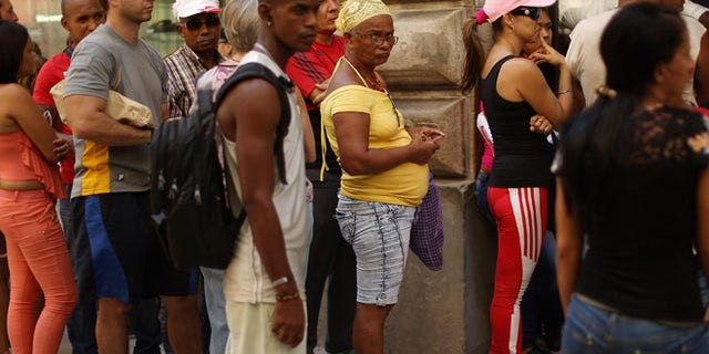 HAVANA, CUBA - AUGUST 13: Cubans stand in line for hours outside an ETECSA state-run telecommunication store to add credit to their mobile phone accounts or activate mobile email in the old part of the city August 13, 2015 in Havana, Cuba. U.S. Secretary of State John Kerry will visit Havana Friday and raise the American flag at the reopened U.S. embassy, a symbolic act after the the two former Cold War enemies reestablished diplomatic relations in July. (Photo by Chip Somodevilla/Getty Images)