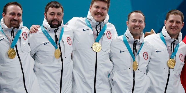 Alternate Joe Polo of the U.S. and his teammates, lead John Landsteiner, second Matt Hamilton, vice-skip Tyler George, and skip John Shuster pose with their gold medals during the victory ceremony.