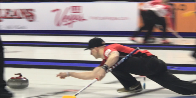 Team USA member, Colin Hufman, throws the rock down the ice at the Men's World Championships in Las Vegas
