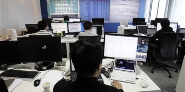 Technicians of AhnLab Inc. work against cyberattacks at the company's Security Operation Center in Seoul, South Korea
