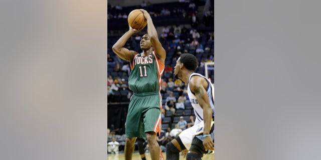 Milwaukee Bucks' Brandon Knight (11) shoots in front of Memphis Grizzlies' Mike Conley during the first half of an NBA preseason basketball game in Memphis, Tenn., Tuesday, Oct. 15, 2013. The Grizzlies won 102-99. (AP Photo/Danny Johnston)