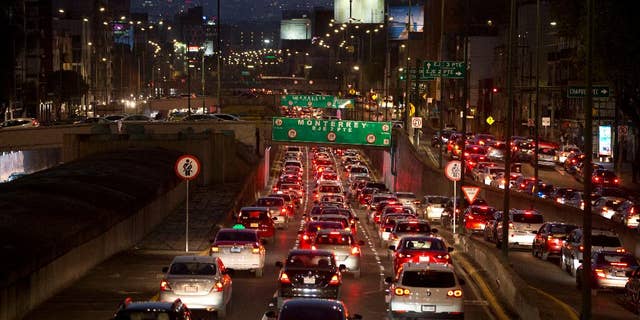 FILE - In this March 30, 2016 file photo, cars sit in evening rush hour traffic in Mexico City. Mexican authorities issued a new smog alert Saturday, May 14, 2016, for the capital after ozone levels rose above 150 percent of acceptable limits. On Sunday 20 percent of vehicles will be barred from the streets of the capital and the surrounding suburbs. If conditions don’t improve, that will increase to 40 percent on Monday. (AP Photo/Rebecca Blackwell, File)