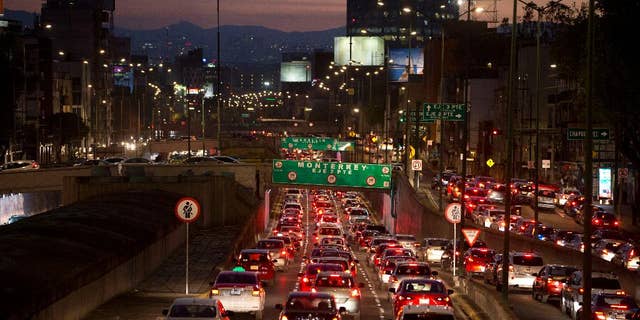 FILE - In this March 30, 2016 file photo, cars sit in evening rush hour traffic in Mexico City. Mexican authorities issued a new smog alert Saturday, May 14, 2016, for the capital after ozone levels rose above 150 percent of acceptable limits. On Sunday 20 percent of vehicles will be barred from the streets of the capital and the surrounding suburbs. If conditions don’t improve, that will increase to 40 percent on Monday. (AP Photo/Rebecca Blackwell, File)