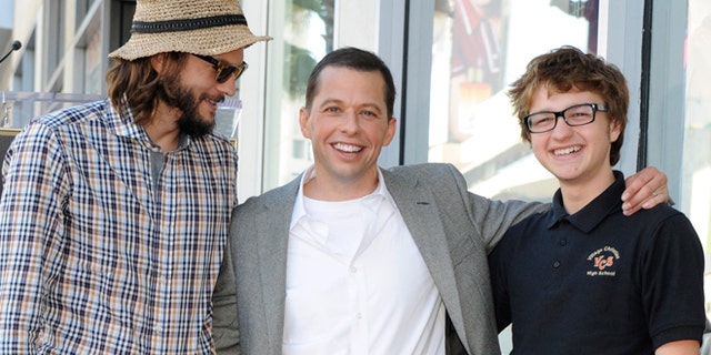 Angus T. Jones, right, poses with his "Two and a Half Men" costars.