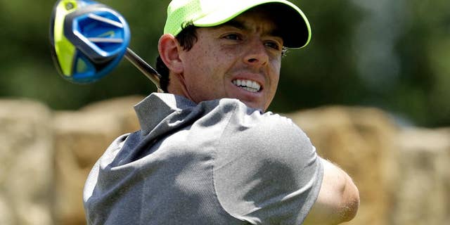 Rory McIlroy, of Northern Ireland, watches his tee shot on the ninth hole during the rain delayed second round of the U.S. Open golf championship at Oakmont Country Club on Saturday, June 18, 2016, in Oakmont, Pa. (AP Photo/Charlie Riedel)