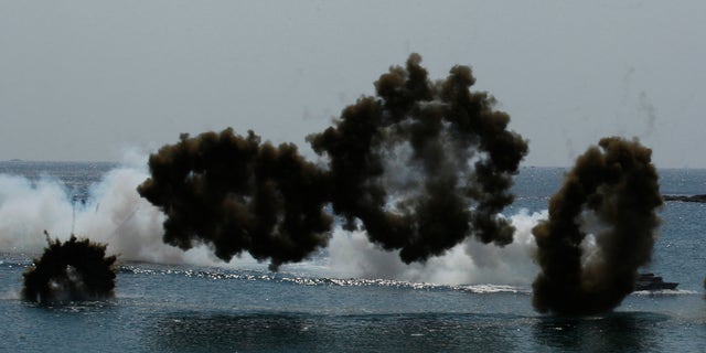 South Korean Marine LVT-7 landing craft sail to shores in a smoke screen during the U.S.-South Korea joint military exercises called Ssangyong 2013 as part of their two-month-long Foal Eagle military exercises in Pohang, south of Seoul, South Korea, Friday, April 26, 2013. (AP Photo/Kin Cheung)