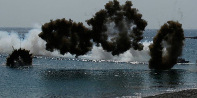 South Korean Marine LVT-7 landing craft sail to shores in a smoke screen during the U.S.-South Korea joint military exercises called Ssangyong 2013 as part of their two-month-long Foal Eagle military exercises in Pohang, south of Seoul, South Korea, Friday, April 26, 2013. (AP Photo/Kin Cheung)