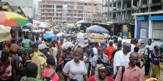 People walking in Conakry street, Guinea, September 24, 2013