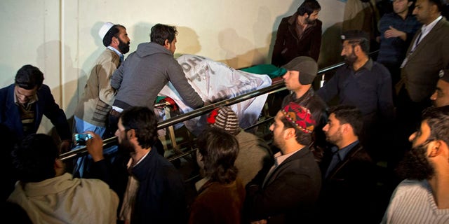 Pakistani volunteers move remains of plane crash victims to a mortuary at a hospital, in Abbottabad, Pakistan, Wednesday, Dec. 7, 2016. Pakistans national carrier says one of its planes crashed shortly after takeoff from the northern city of Chitral with 48 people aboard. A spokesman for the Interior Ministry said there were no survivors. Rescuers told The Associated Press that the victims bodies were beyond recognition. (AP Photo/B.K. Bangash)