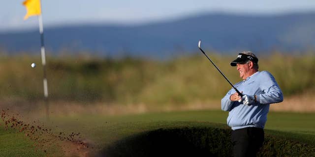 Scotland's Colin Montgomerie plays out of the bunker on the first hole during the first round of the British Open Golf Championship at the Royal Troon Golf Club in Troon, Scotland, Thursday, July 14, 2016. (David Davies/PA via AP)