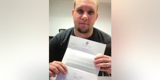 Joshua Holt in a Venezuelan jail holding a letter he received last Friday from Sen. Orrin Hatch.
