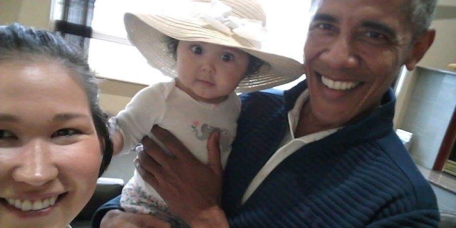 July 3: .S. President Barack Obama holds Jackinsky's 6-month-old baby girl while posing for a selfie with the pair at a waiting area at Anchorage International Airport, in Anchorage, Alaska. Jackinsky said Obama walked up to her and asked, "Who is this pretty girl?"