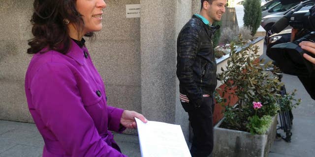 Bernadett Szel, a lawmaker from the green party Politics Can Be Different, shows a copy of an appeal she presented to the Constitutional Court outside the court's headquarters on Friday, April 21, 2017. Szel and other opposition lawmakers are seeking the repeal of amendments to the law on higher education they say seeks to shut down Budapest-based Central European University, founded by billionaire philanthropist George Soros. (AP Photo/Pablo Gorondi)