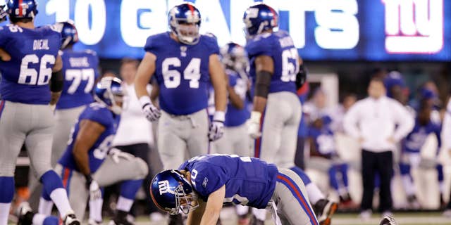 New York Giants quarterback Eli Manning (10) reacts after being sacked by Philadelphia Eagles defensive end Jason Babin and fumbling the ball during the fourth quarter of an NFL football game, Sunday, Nov. 20, 2011 in East Rutherford, N.J. The Giants lost the game 17-10. (AP Photo/Kathy Willens)
