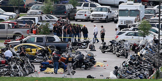 In this May 17, 2015 file photo, authorities investigate a shooting in the parking lot of Twin Peaks restaurant in Waco, Texas.
