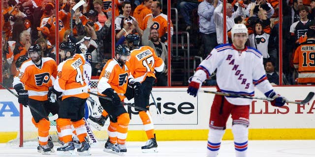 Philadelphia Flyers' Wayne Simmonds, second from right, celebrates his hat trick with teammates during the second period in Game 6 of an NHL hockey first-round playoff series against the New York Rangers, Tuesday, April 29, 2014, in Philadelphia. (AP Photo/Chris Szagola)