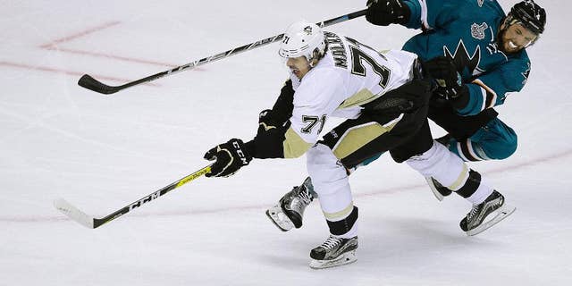 Pittsburgh Penguins' Evgeni Malkin, left, moves the puck past San Jose Sharks' Brenden Dillon during the second period of Game 4 of the NHL hockey Stanley Cup Finals, Monday, June 6, 2016, in San Jose, Calif. (AP Photo/Eric Risberg)