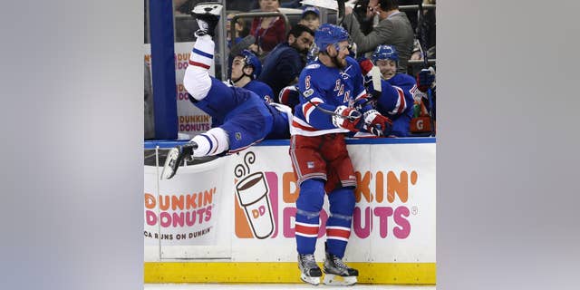 New York Rangers' Kevin Klein, right, checks Montreal Canadiens' Torrey Mitchell over the boards during the third period in Game 3 of an NHL hockey first-round playoff series, Sunday, April 16, 2017, in New York. The Canadiens defeated the Rangers 3-1. (AP Photo/Seth Wenig)