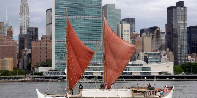 In this June 8, 2016, file photo, the traditional Polynesian voyaging canoe Hokulea, on an around-the-world journey, sails by the United Nations on New York's East River, during the World Oceans Day observance.