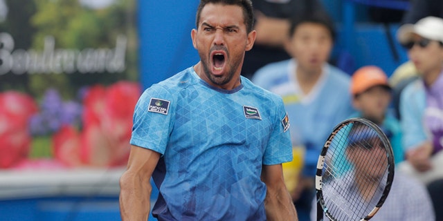 Victor Estrella from the Dominican Republic celebrates a winning a point against Spain's Feliciano Lopez in the final match of the ATP World Tour Ecuador Open Quito tournament, in Quito, Ecuador, Sunday, Feb. 8, 2015. Estrella became the oldest first-time winner of an ATP event in the Open Era, beating top-seeded Lopez. The 34-year-old Dominican won 6-2, 6-7 (5), 7-6 (5) in his first ATP final. He was the first Dominican to reach a top-level ATP final. (AP Photo/Dolores Ochoa)