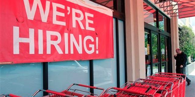 In this April 25, 2011 photo, a "We're Hiring!" sign is shown at Office Depot in Mountain View, Calif. More people sought unemployment benefits last week, the second rise in three weeks, a sign the job market's recovery is slow and uneven.(AP Photo/Paul Sakuma)
