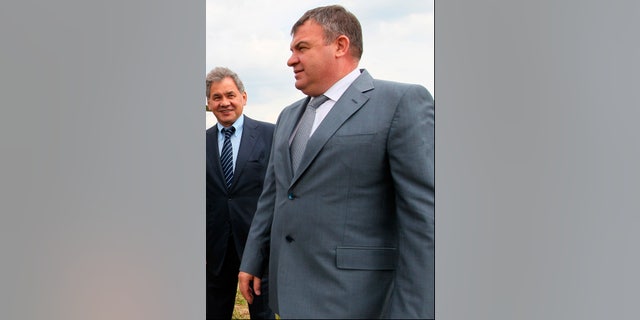 FILE - This Tuesday, June 26, 2012 file photo shows then Defense Minister Anatoly Serdyukov, right, and then Moscow region governor Sergei Shoigu are photographed together at the village of Petrovskopye, Moscow region. Russia’s main investigative agency has filed charges against Serdyukov Thursday, Nov. 28, 2013, accusing him of using servicemen and government funds to build a road to a vacation home and do landscaping work on the property. If convicted, Serdyukov could face up to five years in prison. (AP Photo/RIA Novosti, Yekaterina Shtukina, Government Press service, File)