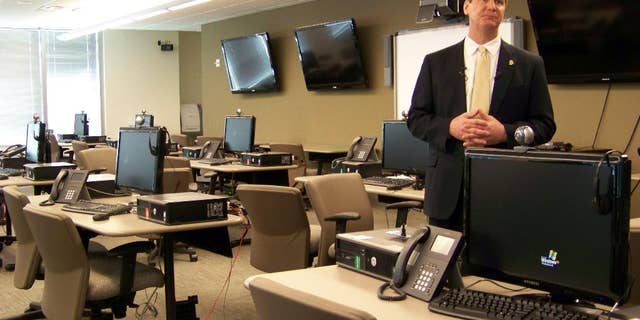 File- This March 9, 2012, file photo shows FBI spokesman Kyle Loven giving a tour of the Emergency Operations Center at the new Minneapolis-area field office in Brooklyn Center, Minn. Loven, spokesman for the Minneapolis office of the FBI, said six people were arrested Sunday, April 19, 2015, but gave no further details. An FBI spokesman in San Diego referred questions to Loven. (AP Photo/Amy Forliti, File)