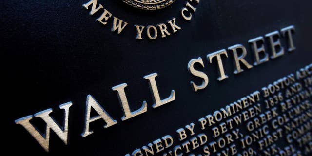 FILE - This Jan. 4, 2010 file photo shows an historic marker on Wall Street in New York. Japan's stock benchmark closed above the 20,000-level for the first time in 15 years Wednesday, April 22, 2015, encouraged by the country's first monthly trade surplus since 2012. European stocks fell, however, and Wall Street was expected to open lower. (AP Photo/Mark Lennihan, File)