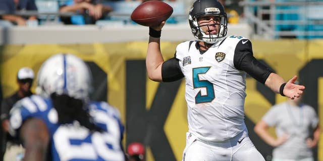 Jacksonville Jaguars quarterback Blake Bortles (5) throws a pass as he is pressured by Indianapolis Colts cornerback Greg Toler (28) during the second half of an NFL football game in Jacksonville, Fla., Sunday, Sept. 21, 2014. Indianapolis won 44-17.(AP Photo/Stephen B. Morton)
