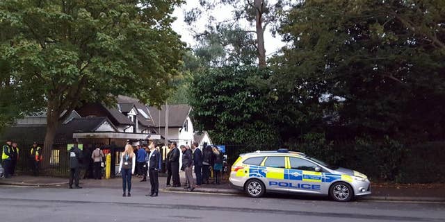 Police and evacuated visitors stand outside London Zoo after a gorilla escaped in London, Thursday, Oct. 13, 2016. London police say an incident involving a gorilla that escaped from its enclosure at the London Zoon has been concluded. There are reports the animal was subdued Thursday with a tranquilizer gun and recaptured. There were no initial reports of injuries. (Lynne Chapman via AP)