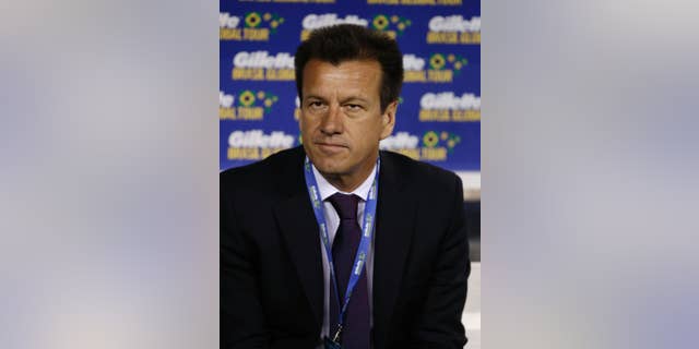 Brazil coach Dunga sits on the bench before an international soccer friendly between Ecuador and Brazil, Tuesday, Sept. 9, 2014, in East Rutherford, N.J. (AP Photo/Julio Cortez)
