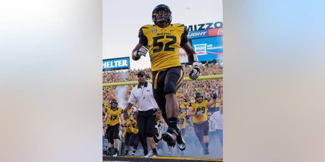 FILE - In this Sept. 8, 2012 file photo, Missouri's Michael Sam (52) runs onto the field along with their teammates before the start of an NCAA college football game against Georgia in Columbia, Mo. Sam was selected in the seventh round, 249th overall, by the St. Louis Rams in the NFL draft Saturday, May 10, 2014. The Southeastern Conference defensive player of the year last season for Missouri came out as gay in media interviews this year. (AP Photo/Jeff Roberson, File)