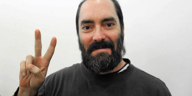 FILE - In this Nov. 4, 2009 file photo, Ultra-Orthodox West Bank settler Jack Teitel flashes the Victory sign inside a court in Petah Tikva, Israel. The Jerusalem District Court handed Jack Teitel, originally from Florida, two life sentences for the deaths plus additional time for the other crimes Tuesday, April 9, 2013. (AP Photo/Reuven Castro, File)