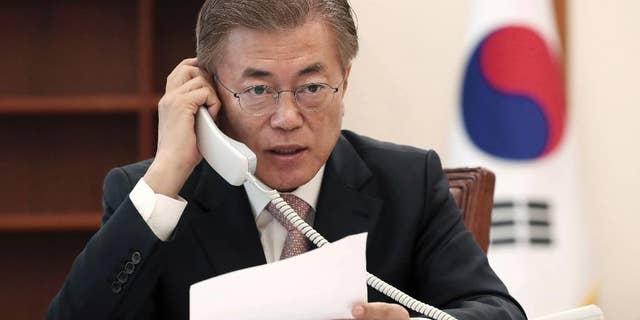South Korean President Moon Jae-in talks on the phone with Chinese President Xi Jinping at the presidential Blue House in Seoul, South Korea, Thursday, May 11, 2017. Moon told his Chinese counterpart that he plans to send a special delegation to Beijing for talks on North Korea and a contentious U.S. missile-defense shield, Seoul officials said Thursday. (Yonhap via AP)