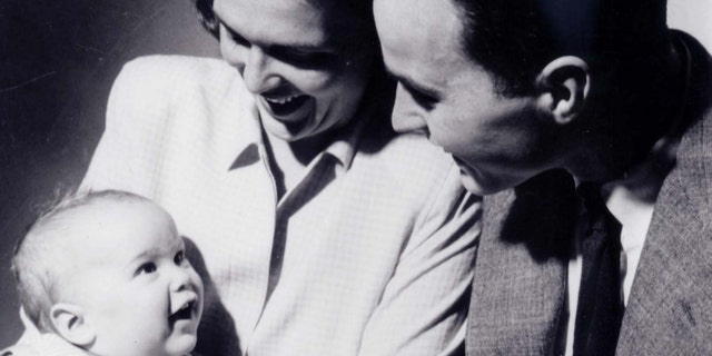 Future first lady Barbara Bush holding son George W. Bush as George H.W. Bush looks on in New Haven, Connecticut, in this April 1947 file photo.