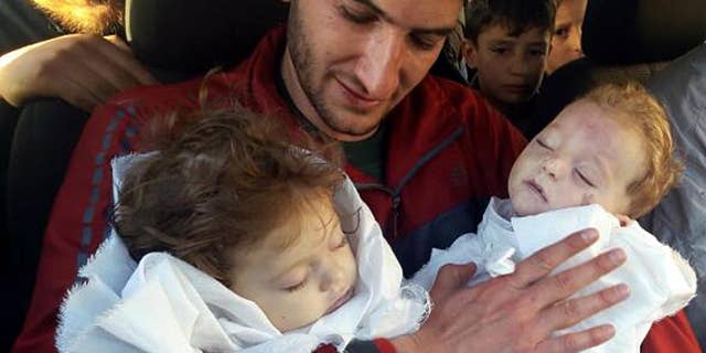 April 4: Abdul-Hamid Alyousef, 29, holds his twin babies who were killed during a suspected chemical weapons attack, in Khan Sheikhoun in the northern province of Idlib, Syria.