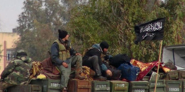 Rebels from Al-Qaeda affiliated Jabhat al Nusra, as they sit on a truck full of ammunition, at Taftanaz air base, that was captured by the rebels, in Idlib province, northern Syria. (AP Photo/Edlib News Network ENN, File)