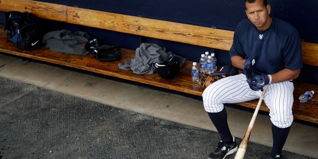 FILE - In this Feb. 25, 2012, file photo, New York Yankees' Alex Rodriguez sits in the dugout during practice at baseball spring training in Tampa, Fla. Baseball is threatening to kick Rodriguez out of the game for life unless the Yankees star agrees not to fight a lengthy suspension for his role in the sport's latest drug scandal, according to a person familiar with the discussions. The person spoke to The Associated Press on Wednesday, July 31, 2013, on condition of anonymity because no statements were authorized. (AP Photo/Matt Slocum, File)