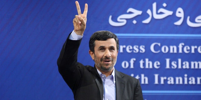 June 7: Iranian President Mahmoud Ahmadinejad flashes a victory sign as he arrives for his press conference in Tehran, Iran.