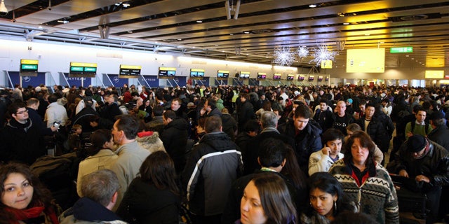 Dec. 20: Passengers wait for their flights, which were disrupted by snow and freezing temperatures, inside Terminal 4 at London's Heathrow Airport. (AP)