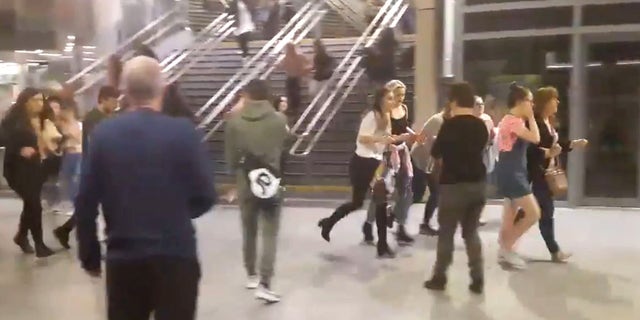 This image shows people running through Manchester Victoria station after an explosion at Manchester Arena. in Manchester England, Monday May 22, 2017. An apparent suicide bomber set off an improvised explosive device that killed over a dozen people at the end of an Ariana Grande concert on Monday, Manchester police said Tuesday May 23, 2017. The station is very near the arena. (Zach Bruce/PA via AP)