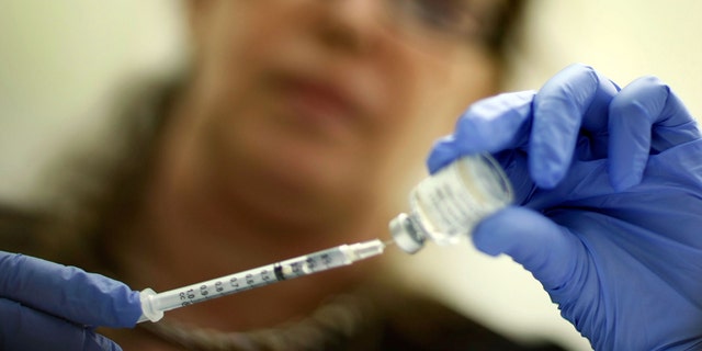 MIAMI - NOVEMBER 03: Marina Spelzini, a registered nurse, measures out an H1N1 vaccine shot at the Miami Dade County Health Department downtown clinic on November 3, 2009 in Miami, Florida. Unlike other parts of the country which are experiencing long lines and shortages of the vaccine, South Florida is not having this problem. The Miami-Dade County Health Department received 195,000 doses of the vaccine but has only given out about 10,100. Broward County has 52,000 doses on hand and has administered about 10,000 doses. (Photo by Joe Raedle/Getty Images)