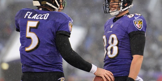 Baltimore Ravens tight end Dennis Pitta, right, celebrates his touchdown with quarterback Joe Flacco in the second half of an NFL football game against the Minnesota Vikings, Sunday, Dec. 8, 2013, in Baltimore. Baltimore won 29-26. (AP Photo/Nick Wass)