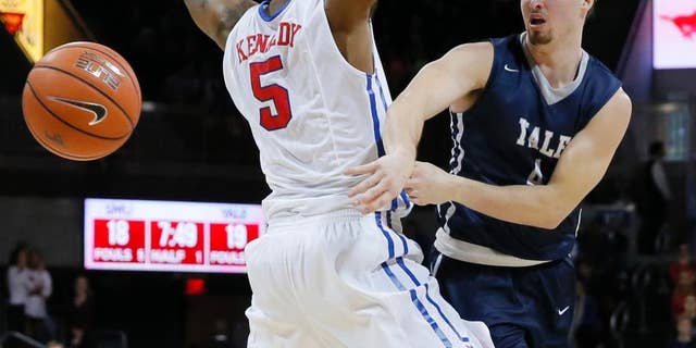 FILE - In this Nov. 22, 2015 FILE photo, Yale's Jack Montague, right, passes the ball around SMU's Markus Kennedy during an NCAA college basketball game in Dallas. Montague's attorney said he was expelled from Yale in Feb. 2016, because of a sexual assault allegation. Montague filed a federal lawsuit over the expulsion, alleging the school mishandled information that originated with someone other than the alleged victim. (AP Photo/Tony Gutierrez, File)