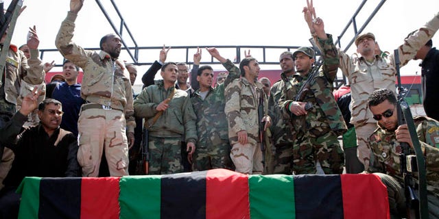 April 19: Libyan rebels surround the coffin of a comrade, whom they say was killed by forces loyal to Mouammar al-Qaddafi in Brega, during a funeral in Benghazi.