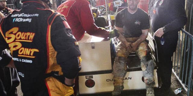 An injured crew member receives medical attention after a fire on pit road during the NASCAR Xfinity series auto race at Richmond International Raceway, in Richmond, Va., Friday April 24, 2015. (Skip Rowland/Richmond Times-Dispatch via AP)