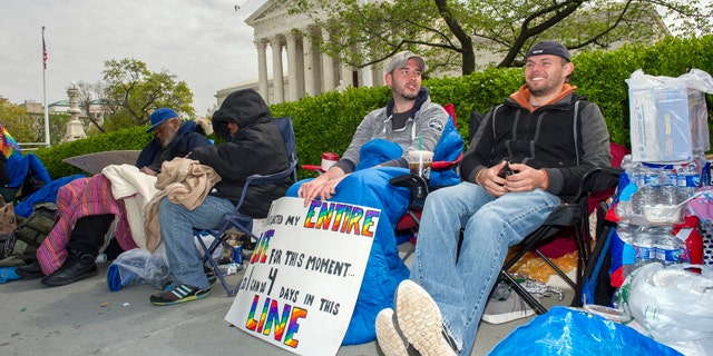 April 27, 2015: Sean Varsho, 28, of Chicago, left, and Brandon Dawson, 26, of Warrenton Va., have been waiting in line for the past three days for a seat for Tuesday's Supreme Court hearing on gay marriage. The opponents of same-sex marriage are urging the court to resist embracing what they see as a radical change in society's view of what constitutes marriage. (AP Photo/Cliff Owen)